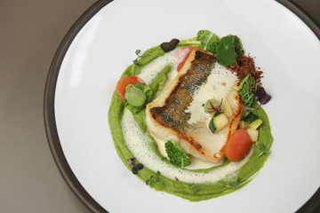 Pike perch fillet with cauliflower puree, greens and white wine sauce