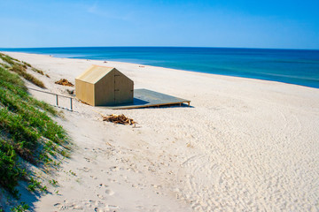 Beautiful sandy beach with dunes in Nida - Curonian Spit and Baltic Sea, Nida, Klaipeda, Lithuania, Unesco heritage with wooden house on the shore