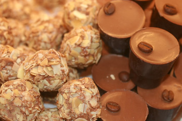 Chocolates with nuts. Texture of candy. Confectionery.