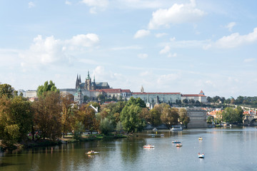 Fototapeta na wymiar Panoramic view of Vltava river, Prague castle, and colorful rooftops of New Town on a bright summer day, in Prague, Czech Republic