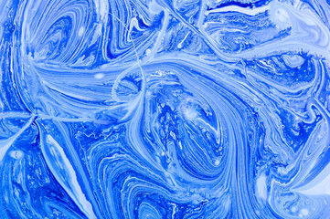 Blue abstract background with marble pattern. White and blue acrylic paints. Marble liquid acrylic texture.