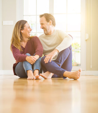 Beautiful romantic couple sitting together on the floor at home