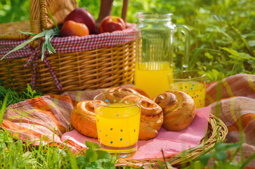 Picnic basket with wine fruit and other products on a natural wooden background. Summer rest ....