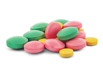 Pile of medical pills in round shape and different colors on white isolated background with shadow.