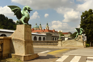 The Dragon Bridge, adorned with famous dragon statues and Cathedral of St. Nicholas at the background in Ljubljana, Slovenia