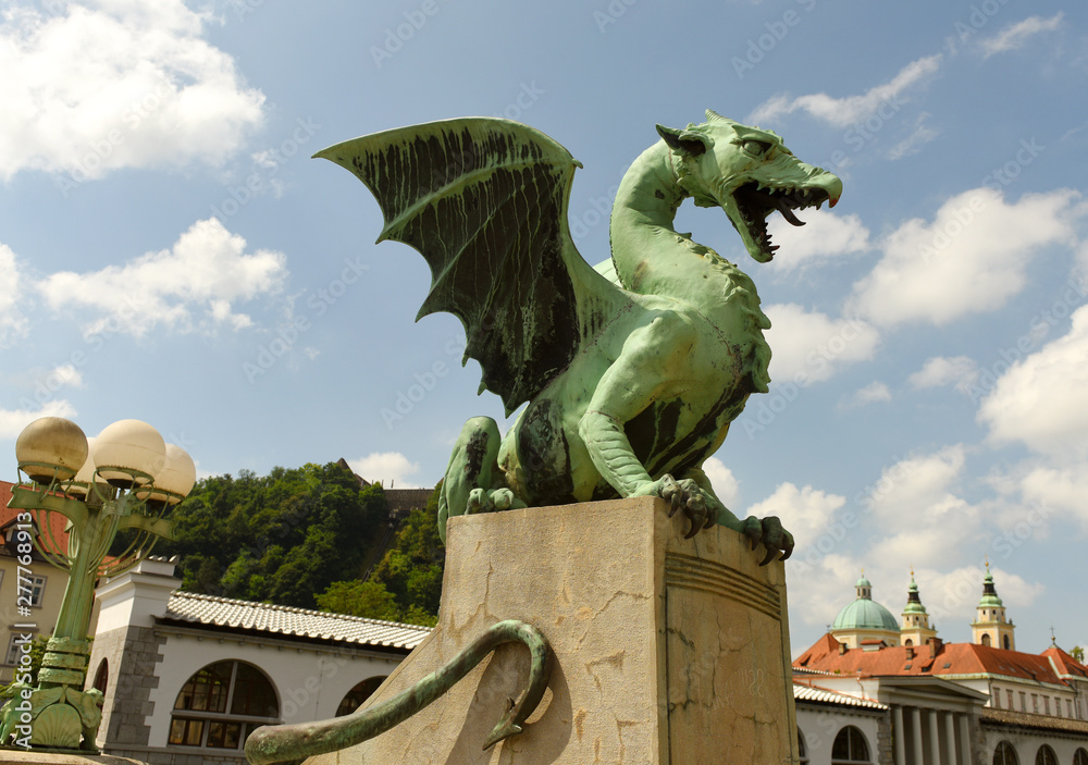 Wall mural the dragon statues at the dragon bridge and cathedral of st. nicholas at the background in center of