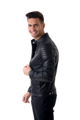 Young handsome man standing in studio shot, isolated on white, wearing black leather jacket and black jeans