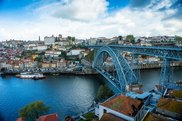 Fototapeta na wymiar Oporto or Porto city skyline, Douro river, traditional boats and Dom Luis or Luiz iron bridge. Portugal, Europe.