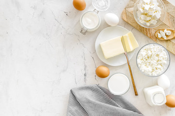 Eggs, butter, milk, yougurt, cottage for natural farm products yougurt marble background top view monochrome copyspace