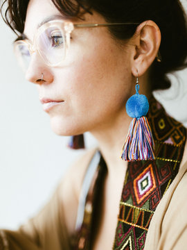 Close up of woman wearing colorful earrings