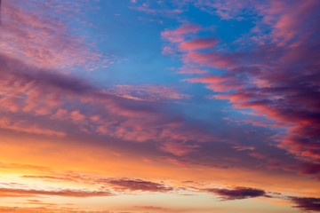 Naklejka na ściany i meble Colored clouds on sunset, amazing sky.