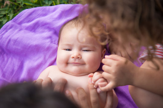 From above shot of cute baby lying and laughing.