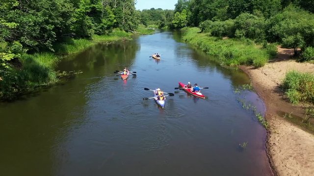 A Group Of People Kayaking On The River