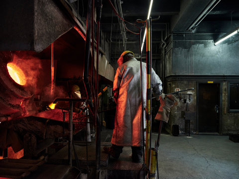 Rear view of man working in factory