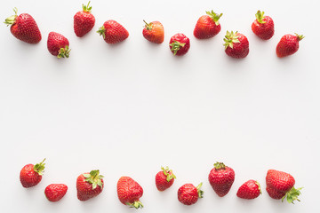 top view of sweet and red strawberries on white background