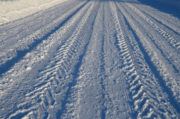 Car tire tread on snow.