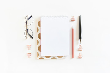 Spiral notepad mockup with glasses and stationery on white background