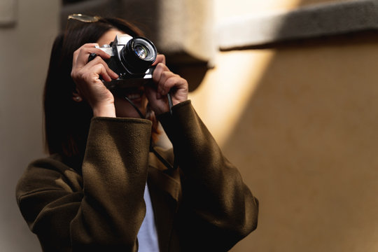 Italy, Florence, young tourist woman taking pictures in the city