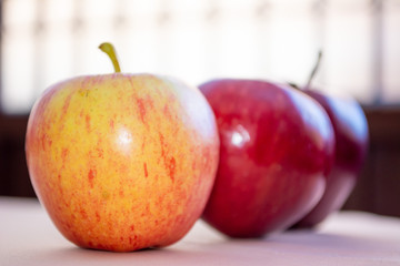 Three red apples in line close up. Healthy food for dieting and important for nutrition.