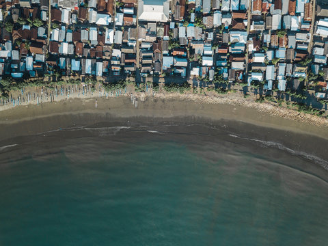 Indonesia, Sumbawa Island, Maluk, Aerial view of coastal town, beach