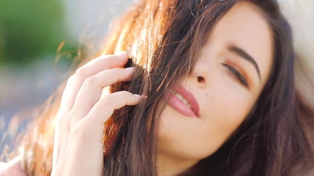 Attractive seductive woman portrait. Cute flirty brunette with disheveled hair
