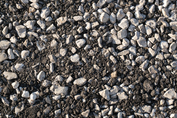 The texture of gravel and crushed asphalt.