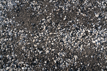The texture of gravel and crushed asphalt.