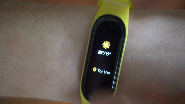Man Checking the Weather on his Smart Band, Close Up