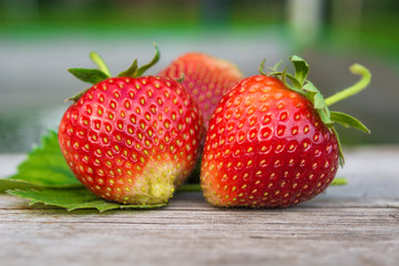   ripe and red strawberries lie on a wooden table. Organic food, healthy nutrient
