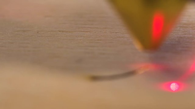 Extreme close up footage cut wood engraving machine with laser make two circle