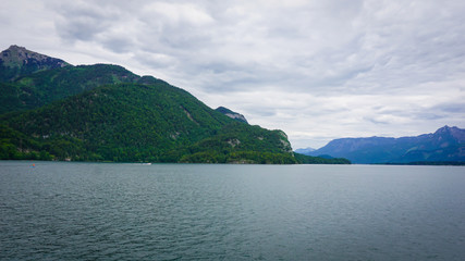 Beautiful Alps landscape withbig lake surrounded by green mountains, valley  and forest