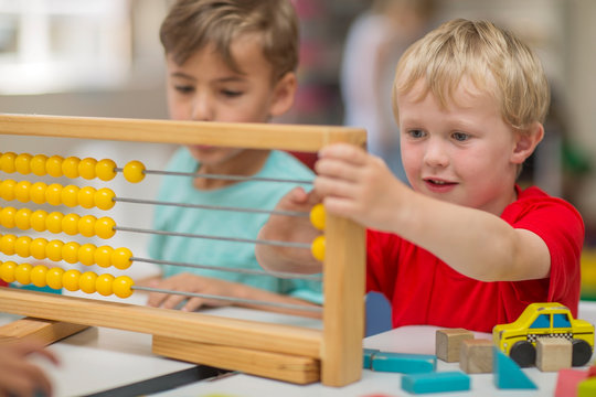 Boys in kindergarten using abacus