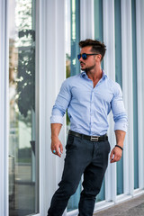 Fototapeta premium Stylish handsome man wearing elegant shirt, outside in urban setting