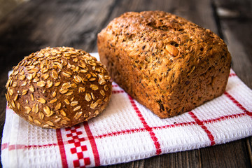 Homemade healthy freshly baked organic whole grain bread with healthy seeds on wooden table