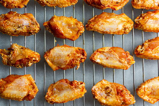 Preparing of spicy chicken wings, grid