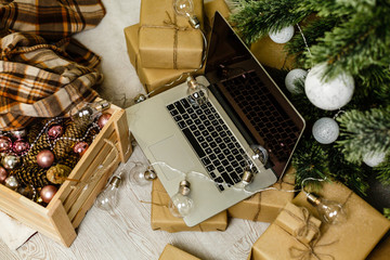 Technology, holidays, christmas, interior and winter concept - cozy bedroom with laptop computer, on bed at cozy home