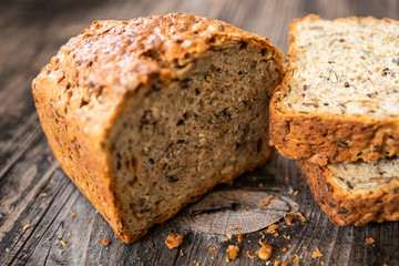Homemade healthy freshly baked organic whole grain bread with healthy seeds on wooden table