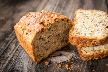 Homemade healthy freshly baked organic whole grain bread with healthy seeds on wooden table
