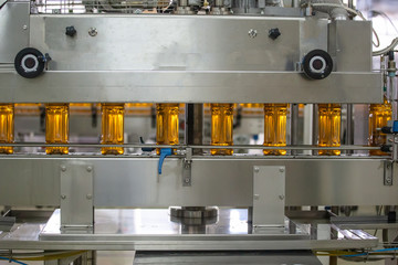 Conveyor belt or line in beverage plant with modern automated industrial machine equipment. Plastic PET bottles