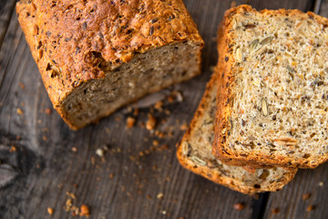 Homemade healthy freshly baked organic whole grain bread with healthy seeds on wooden table