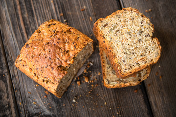 Homemade healthy freshly baked organic whole grain bread with healthy seeds on wooden table