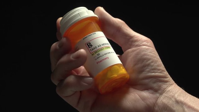 Man holding a prescription pill bottle