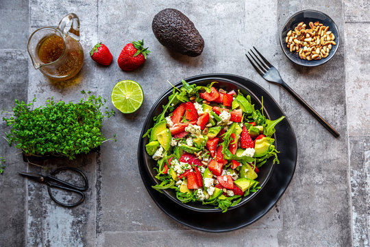 Strawberry avocado salad with feta, rocket, pine nuts and cress