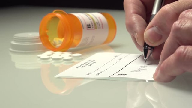 Man writing prescription