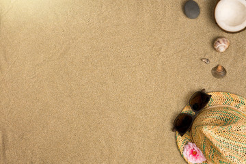 Fototapeta na wymiar Minimalist summer flat lay with, sunglasses and panama hat on sand background