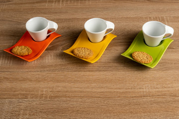 Three cups of coffee placed on desk and waiting to be filled