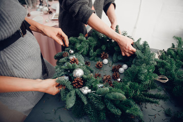 Christmas tree wreath decoration with woman hand workshop DIY © Parilov