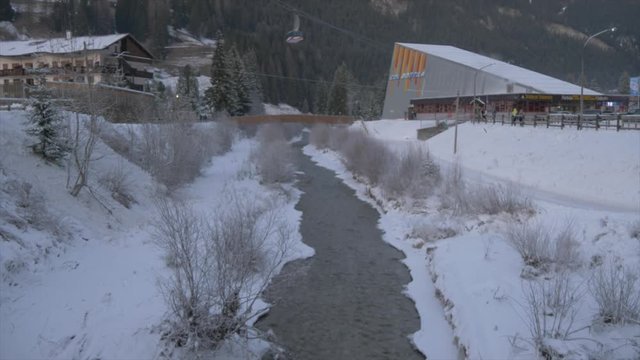 Tilt shot of Avisio River and cable car to Col Rodella, Campitello di Fassa, Province of Trento, Trentino-Alto Adige/Sudtirol, Italy, Europe