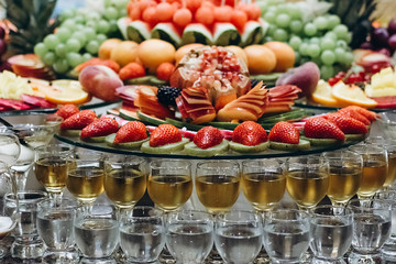 Festive table with cold exotic alcoholic beverages, cocktails and fruits. Celebration or other event