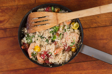 Overhead View of Shrimp Stir Fry in Skillet with Rice and Vegetables on Rustic Cutting Board